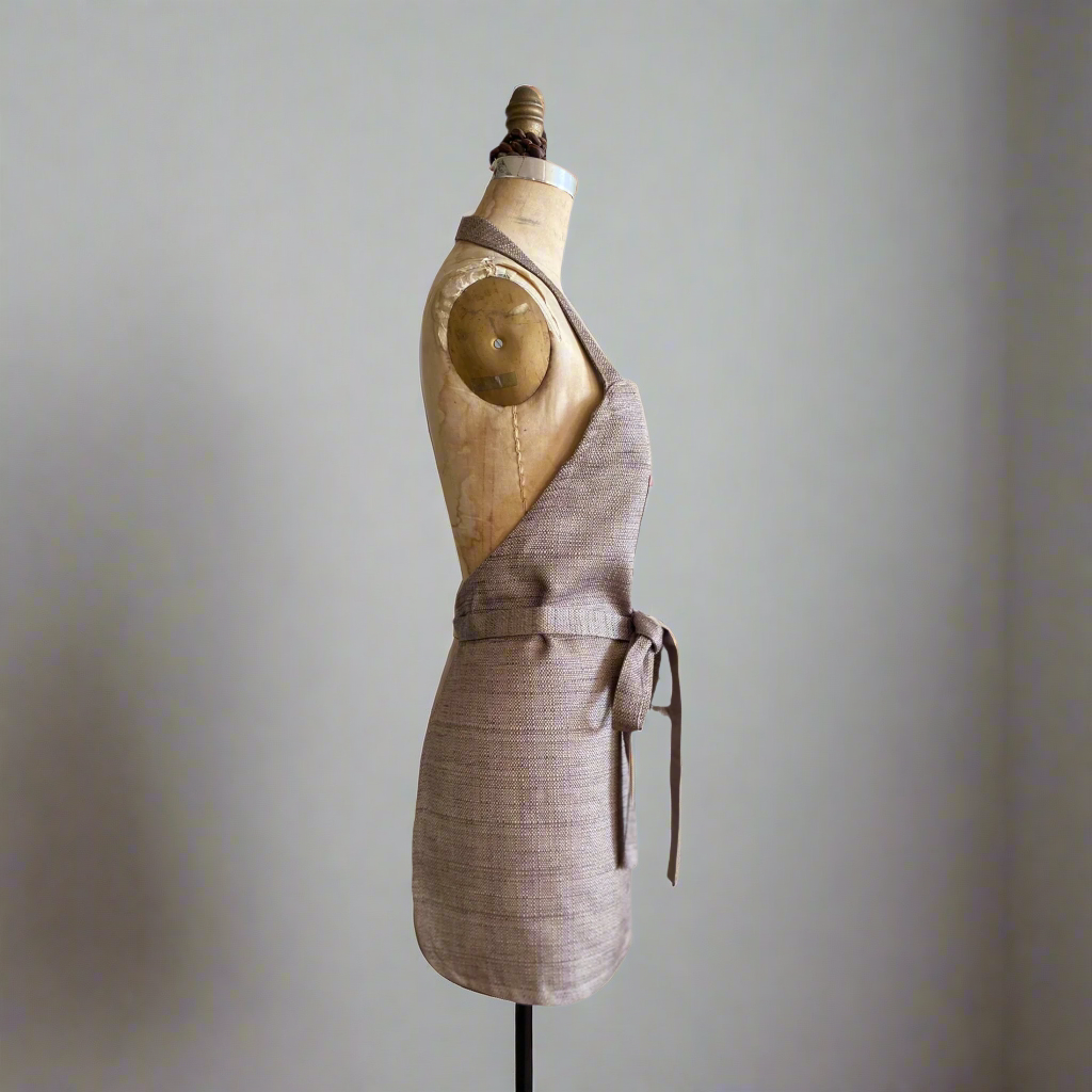 A double-sided apron, showing solid and side angle view displayed on a mannequin