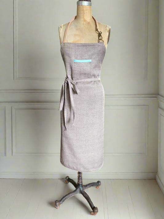 Chameleon apron showing minimalist solid side with aqua rim pocket detail
