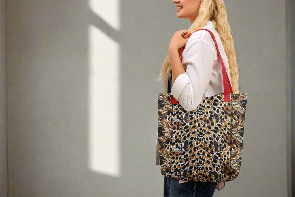 Woman carrying leopard print tote bag with red handles