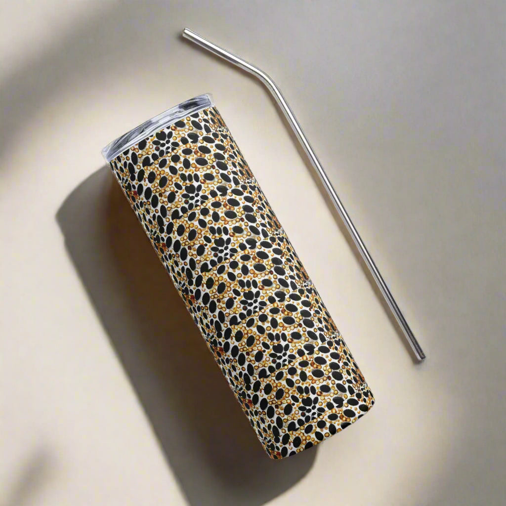 Skinny Snake Stainless steel tumbler on grey background with metal straw next to it
