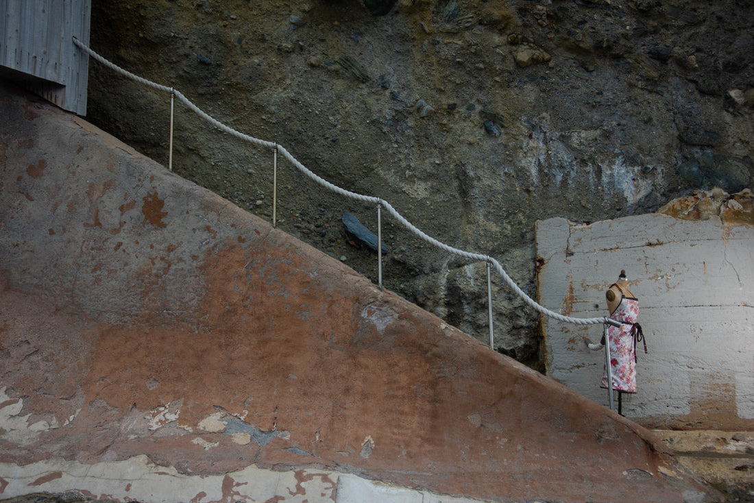 Outdoor stone staircase with mannequin wearing an apron
