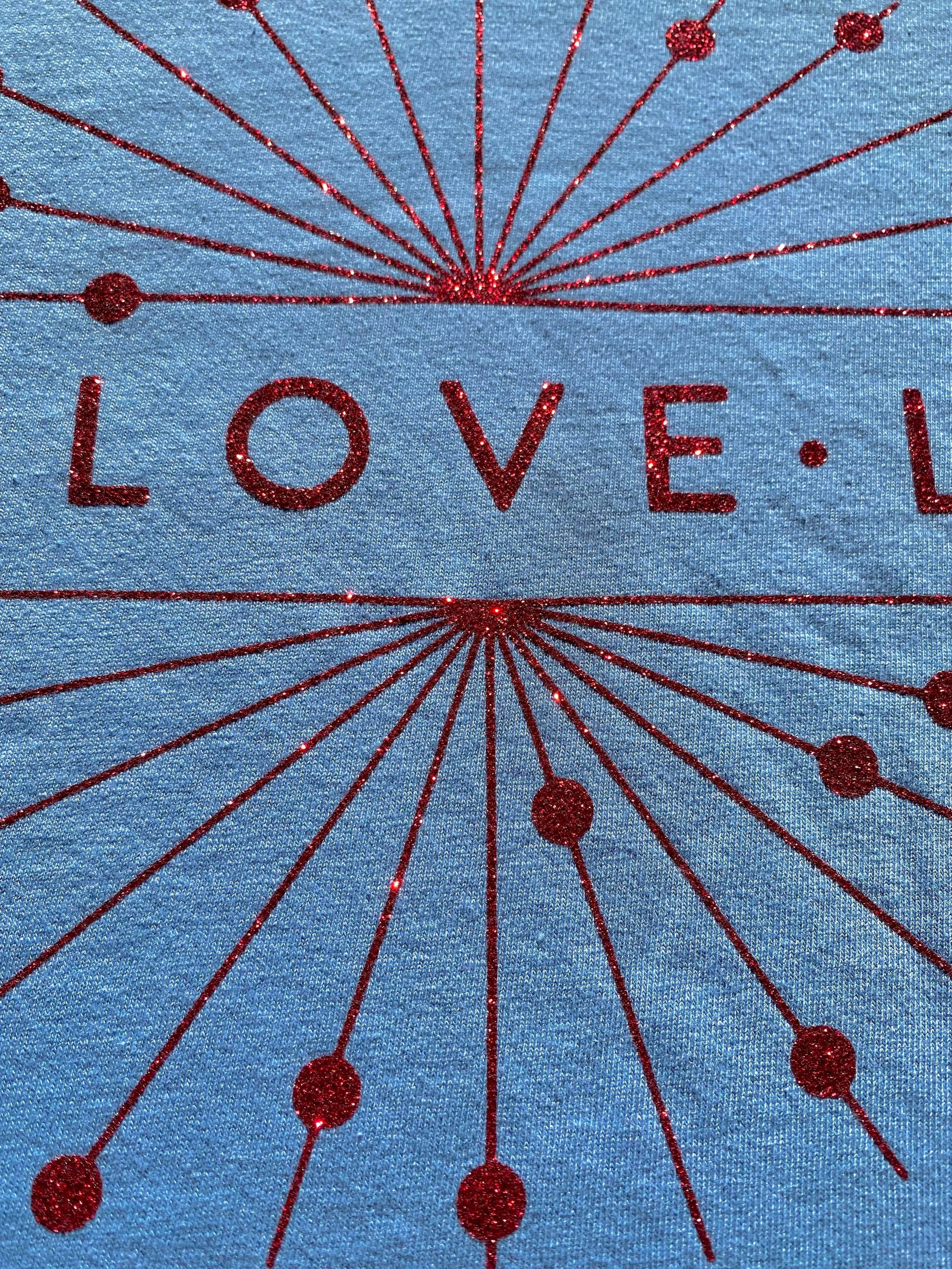Red Sparkle Circle Logo showing glitter detail