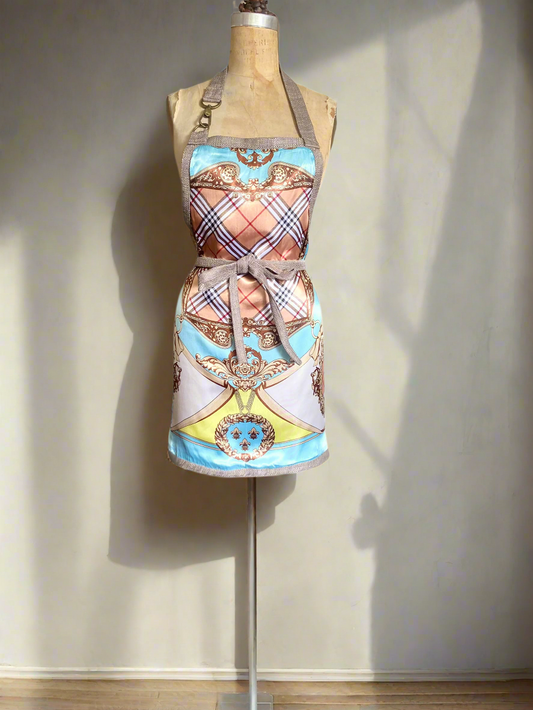 A multicolored, double-sided apron with a front pocket and decorative trim displayed on a mannequin.
