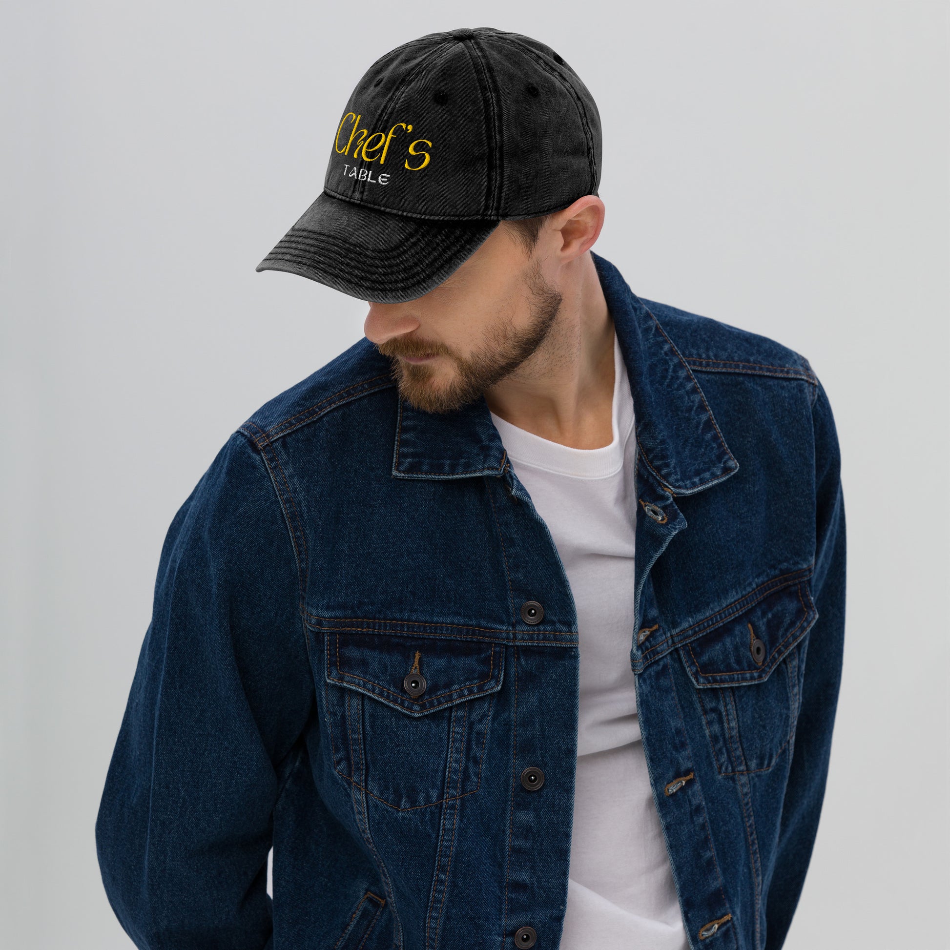 Man with beard looking down wearing the stylish dad cap with culinary themed embroidery 