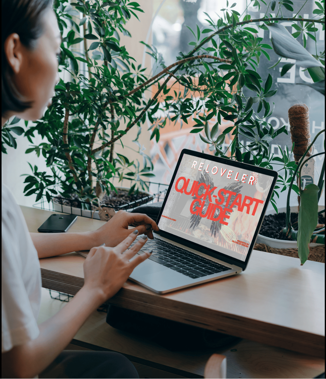 Person using a laptop with Digital culinary tarot Quick Start Guide displayed on laptop screen surrounded by plants.