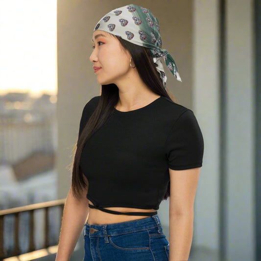 Woman wearing Lunar Dust bandana as headwrap in soft lighting