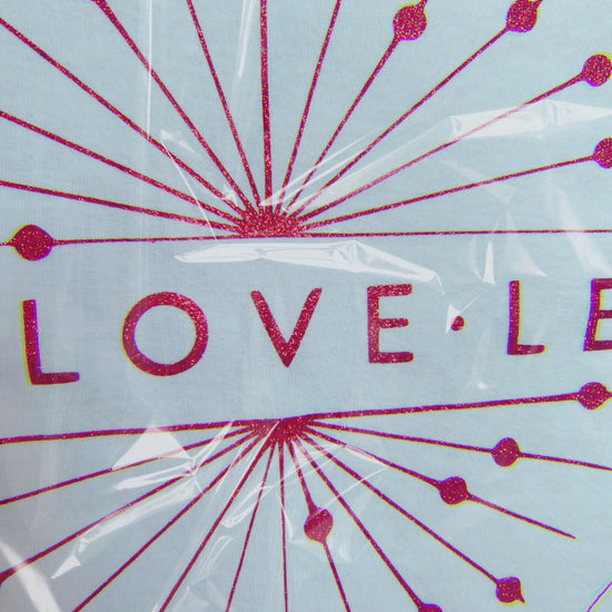 Animated close-up of red sparkle logo through clear protective wrapping, showing glitter detail 