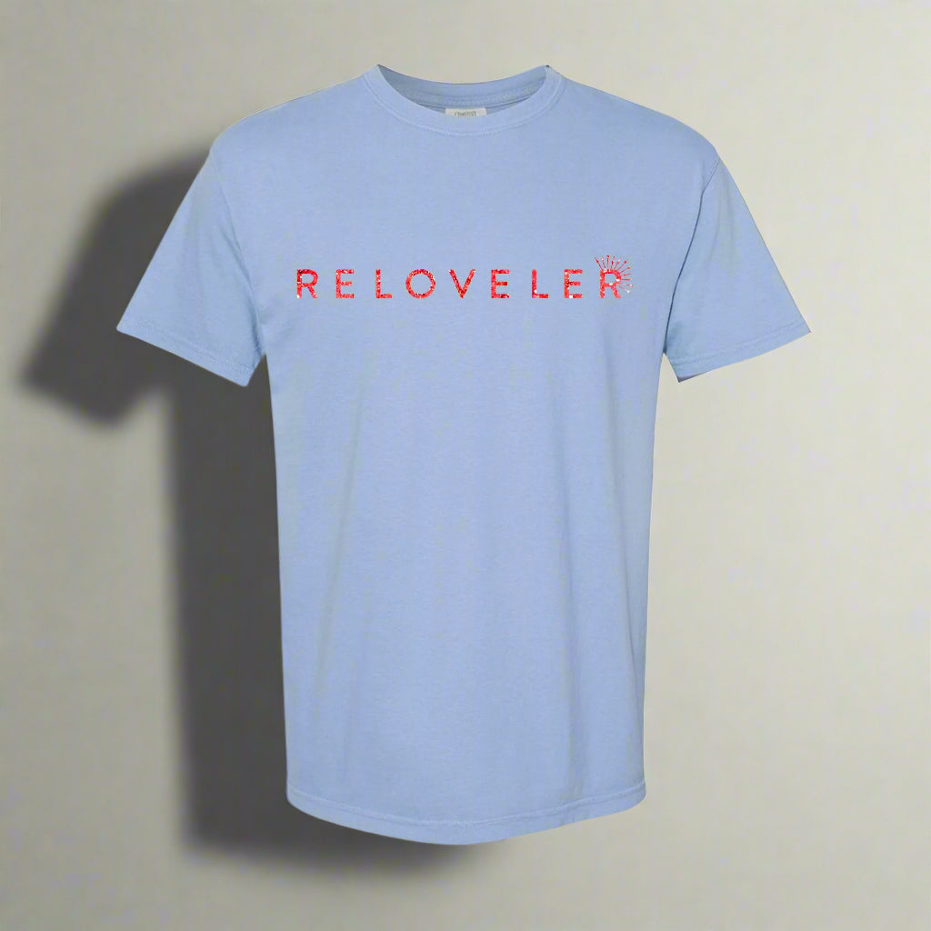 Baby blue t-shirt with red sparkle font and elegant glitter that spells out Reloveler 