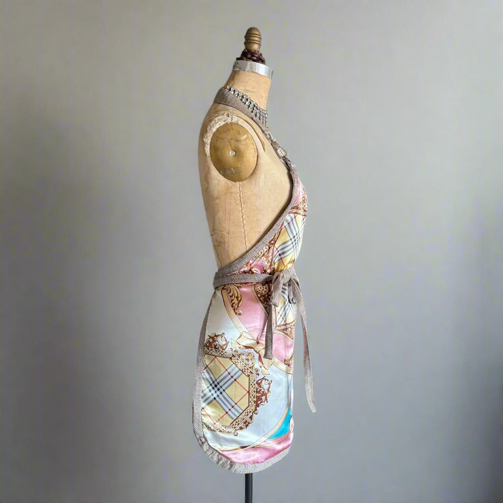 Blush apron on Mannequin showing the side view of the lux pink print side 