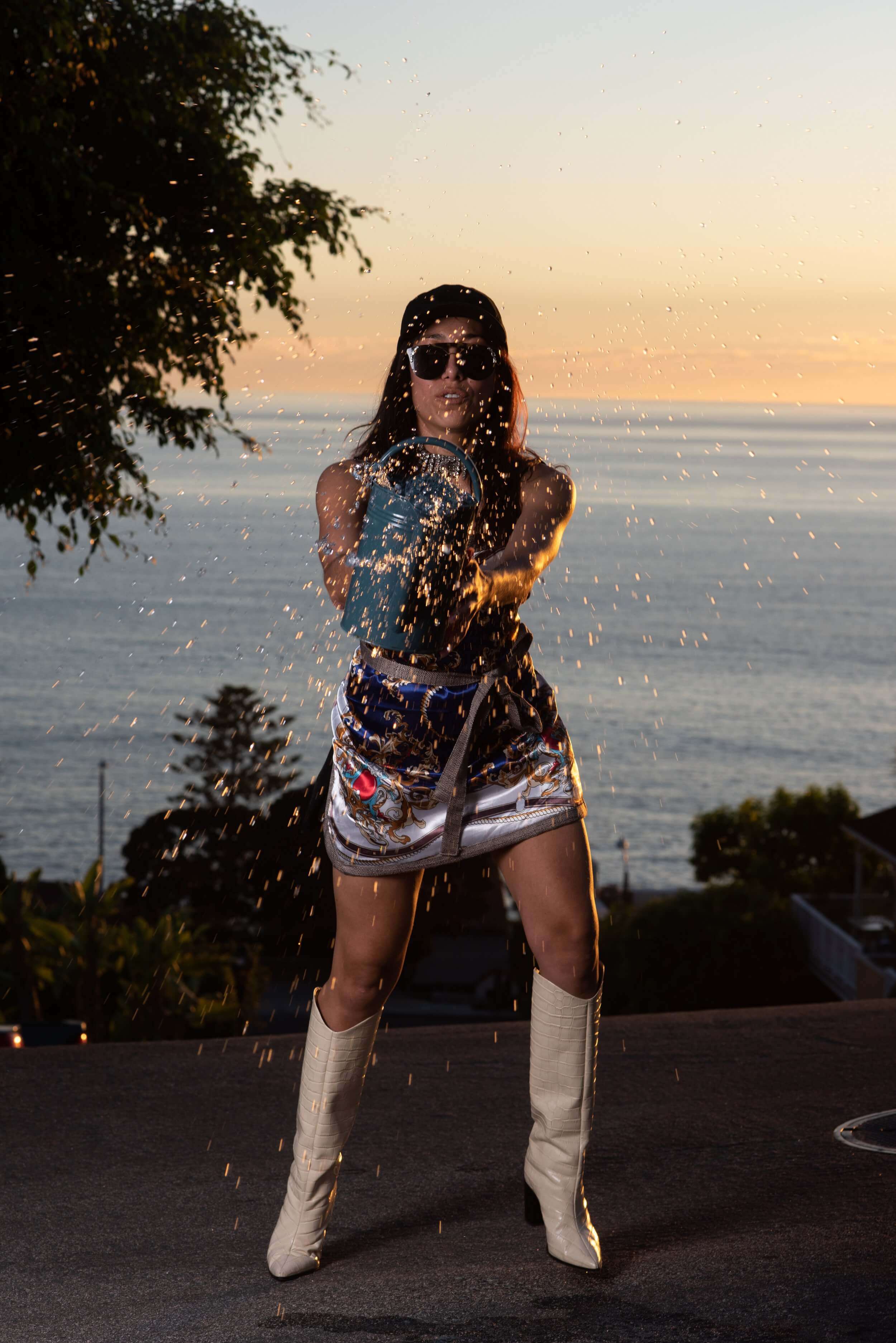 Model wearing Reloveler Designs signature apron outdoors at sunset