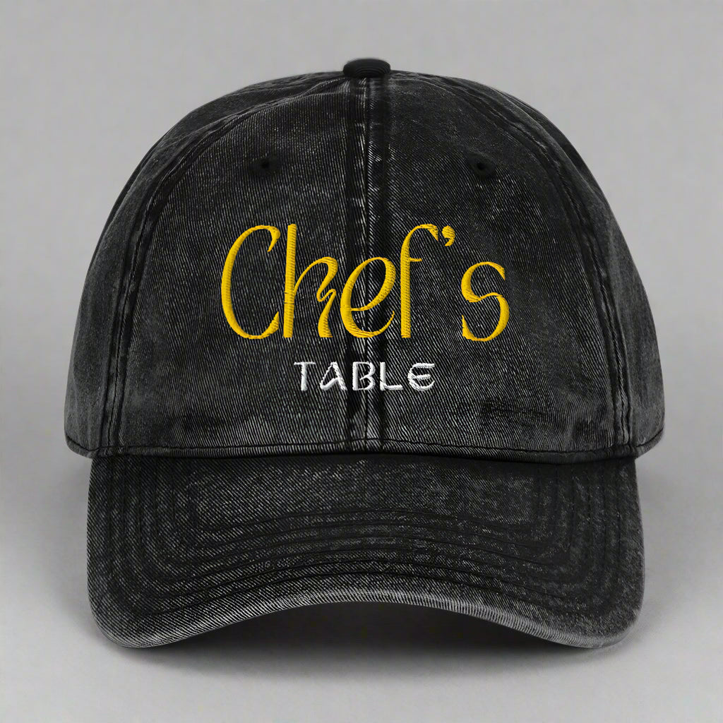 Close-up of the black Chef's Table embroidered cap showing vintage washed finish