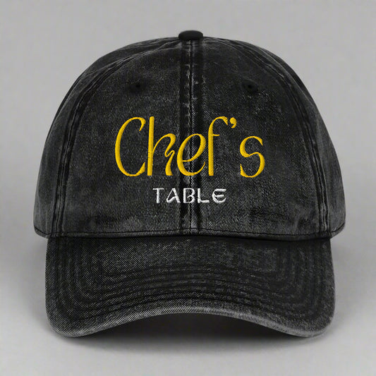 Close-up of the black Chef's Table embroidered cap showing vintage washed finish