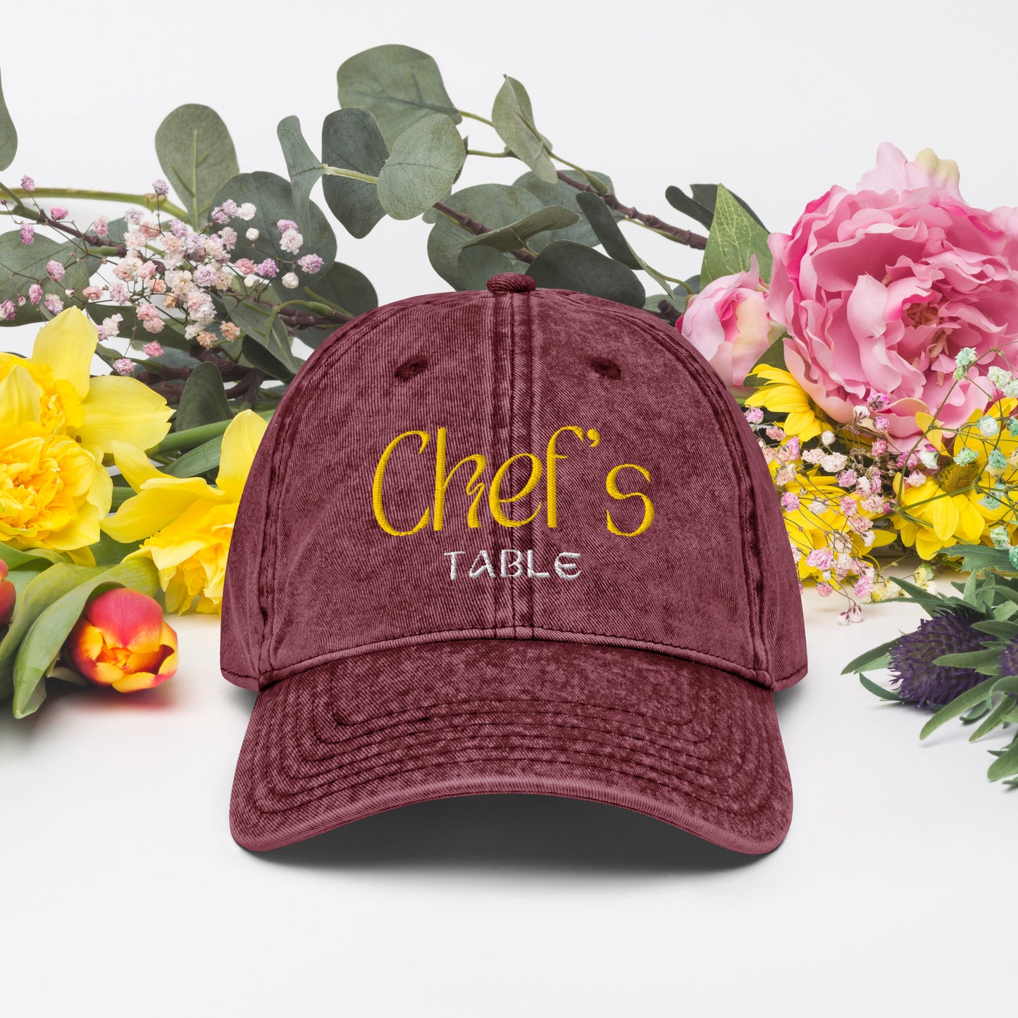 Close-up of maroon Chef's Table embroidered cap showing vintage washed finish