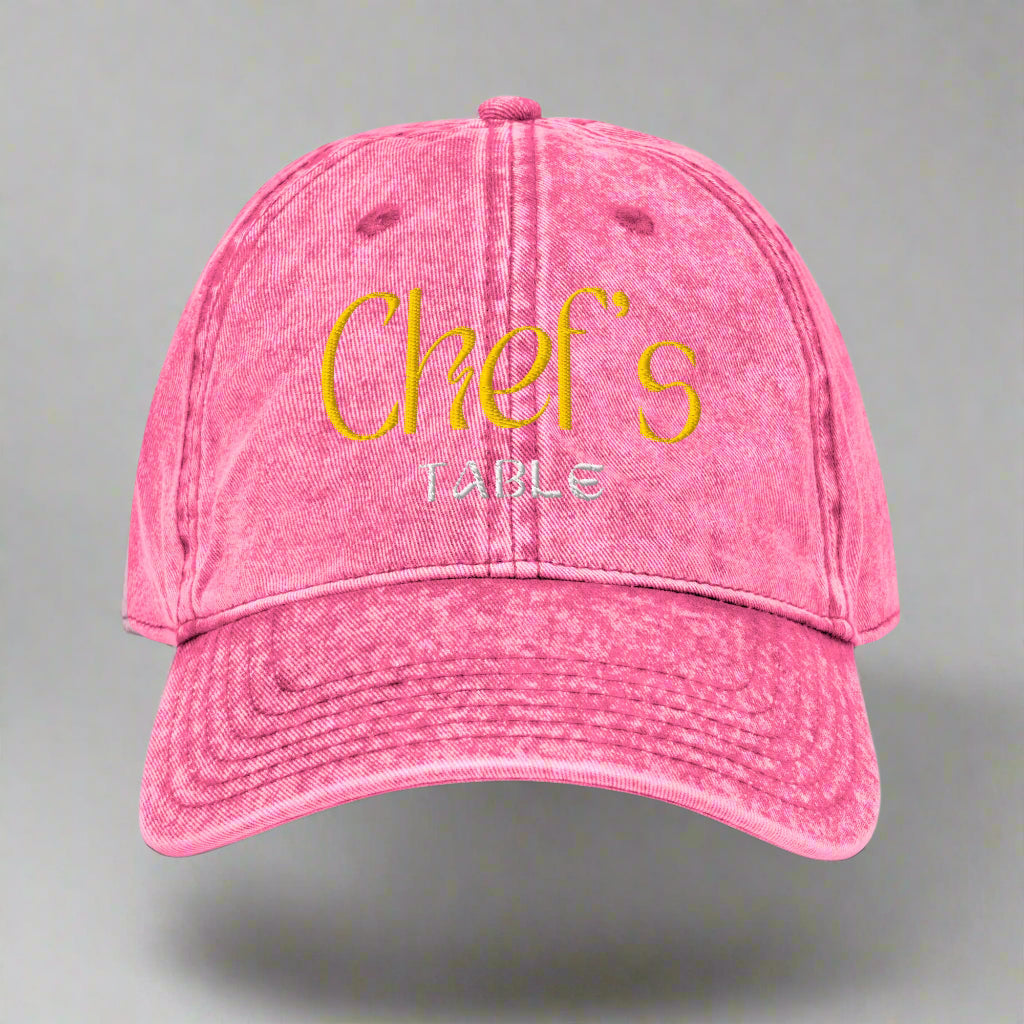 Close-up of pink Chef's Table embroidered cap showing vintage washed finish