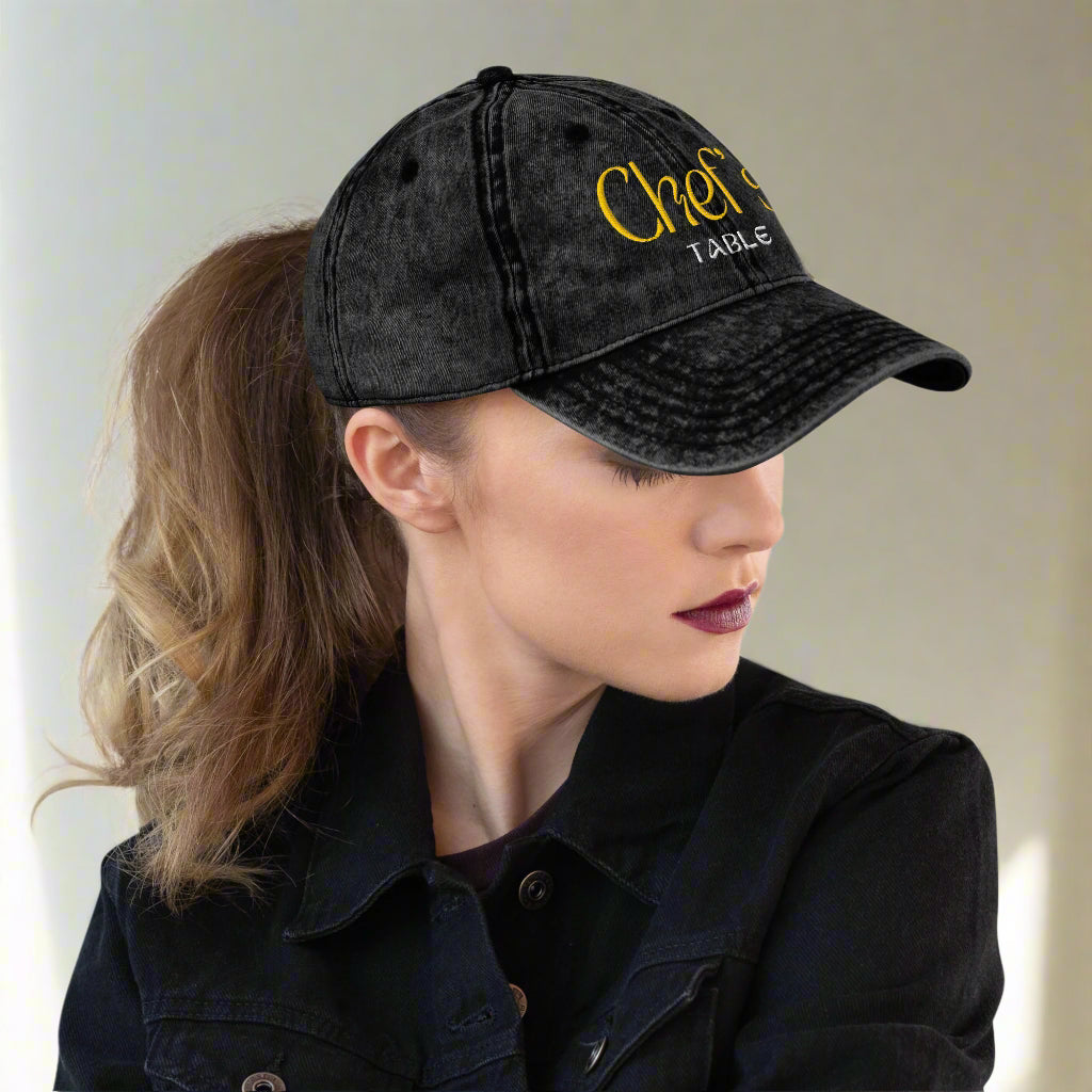 Low profile unstructured cap with culinary themed embroidery as seen on woman with pony tail 